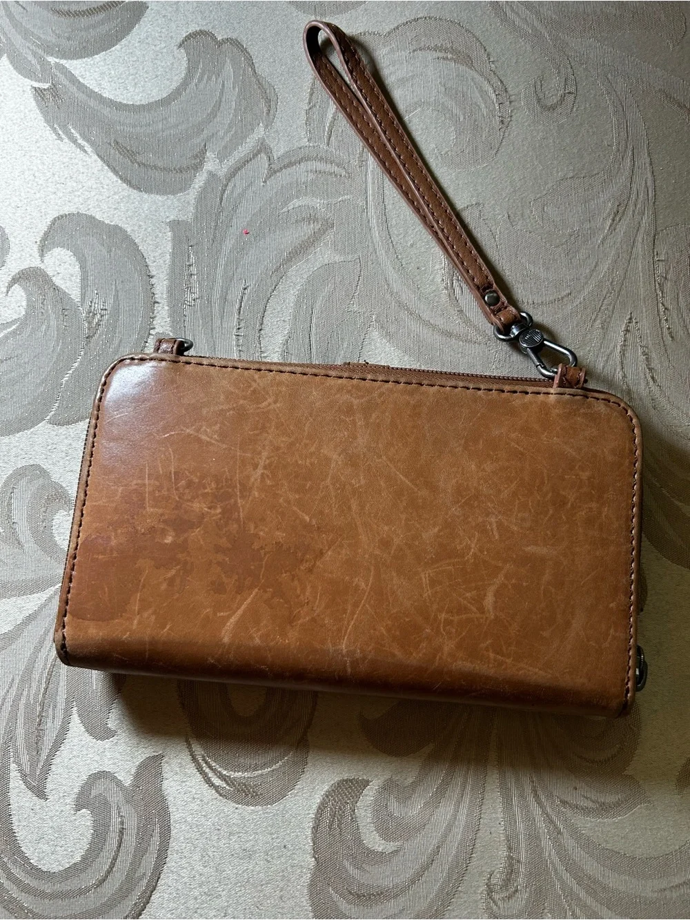 The Sak Smartphone Wristlet Wallet Iris Tobacco Brown Flower Embossed